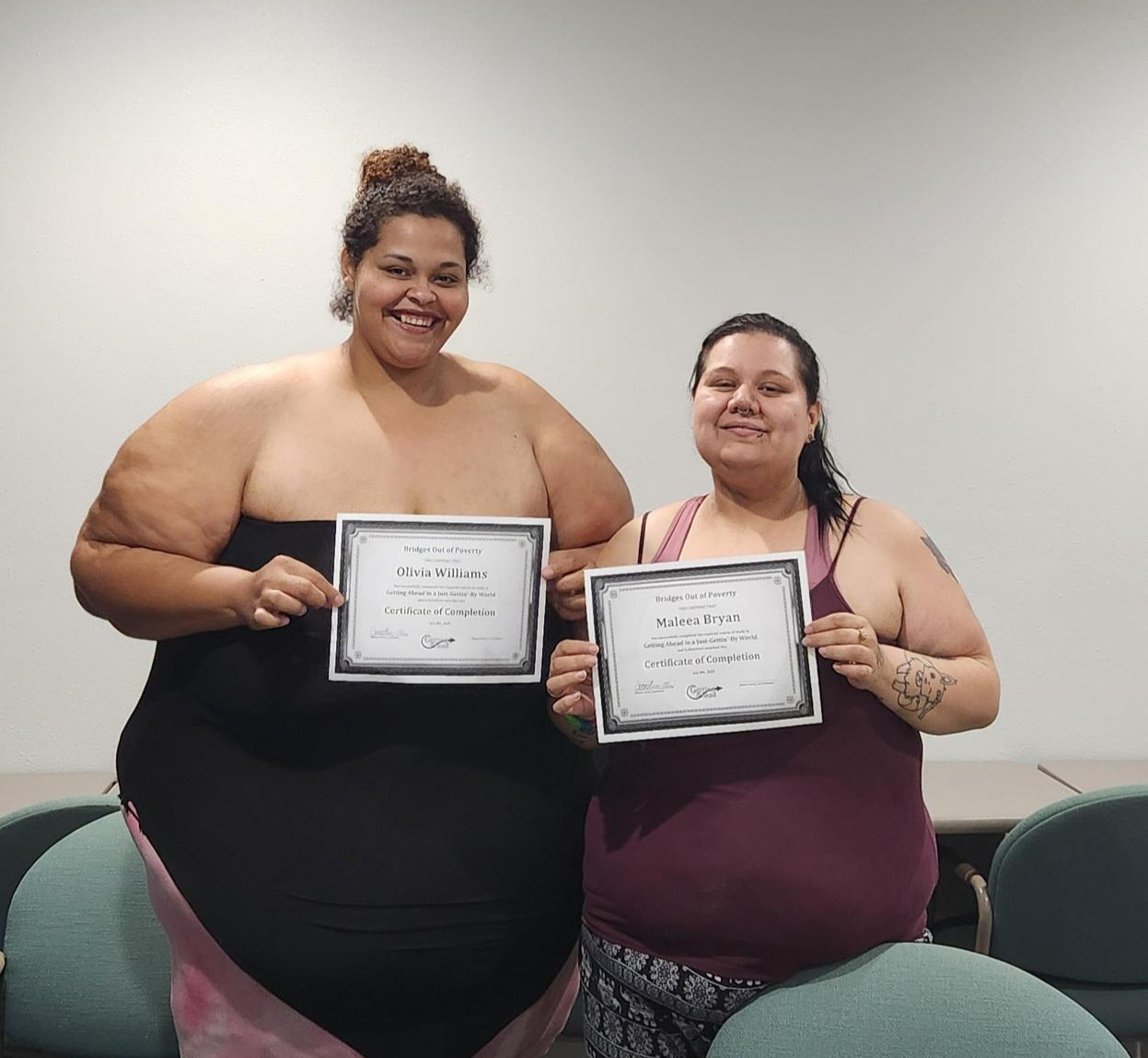 Photo of two women holding their completion certificate