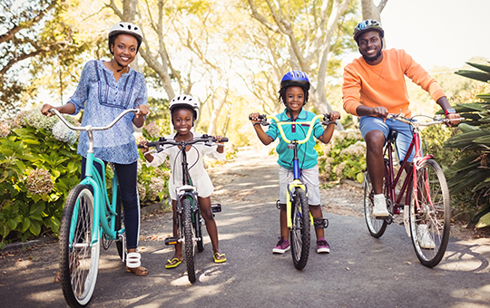 family riding a bike on a trail